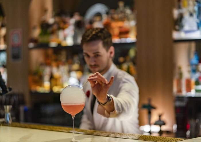 Bartender creating a cocktail at Maybe Sammy cocktail bar in The Rocks, Sydney City